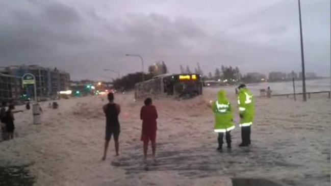 Car emerges from sea foam narrowly missing police