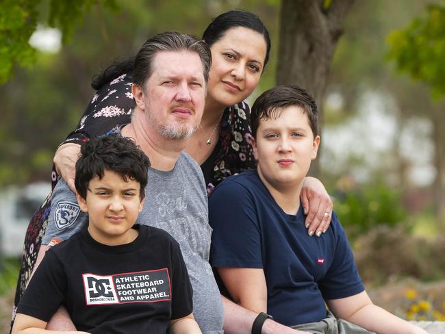 Anthony Michalek with wife Joanne and children Ethan and Adam.Anthony Michalek has been left with a faulty implant in his spine - that was supposed to control his pain, but now cannot be charged and leaves him in agony. Picture:Rob Leeson.