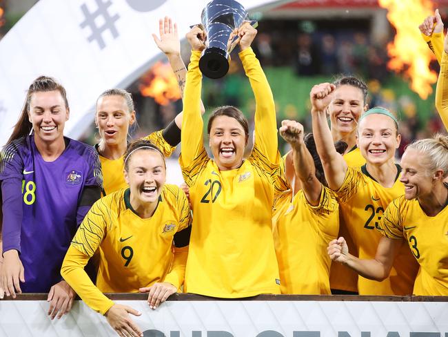 Sam Kerr and her Matildas teammates celebrate the Cup of Nations triumph. 