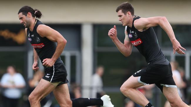 Brodie Grundy, left, leads Mason Cox during a Collingwood training session. Picture: David Crosling/AAP