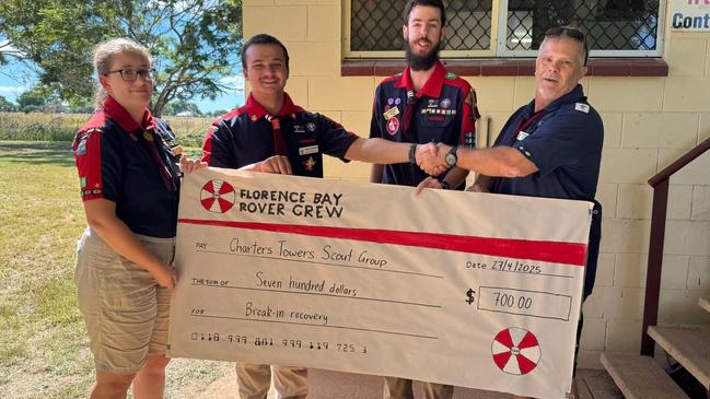 Florence Bay Rover Crew presents a $700 donation to help Charters Towers Scout Group with repairs and security upgrades after the break-in.