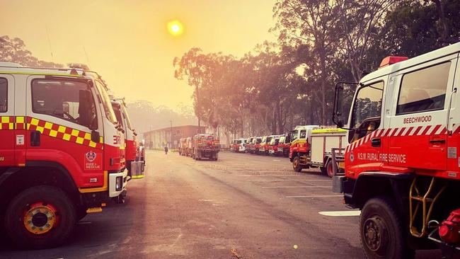 Fire trucks are pictured lined up and ready to battle the massive bushfires raging actross northern NSW, at Port Macquarie. Picture: Instagram Source: https://www.instagram.com/p/B4srbBRBimJ/