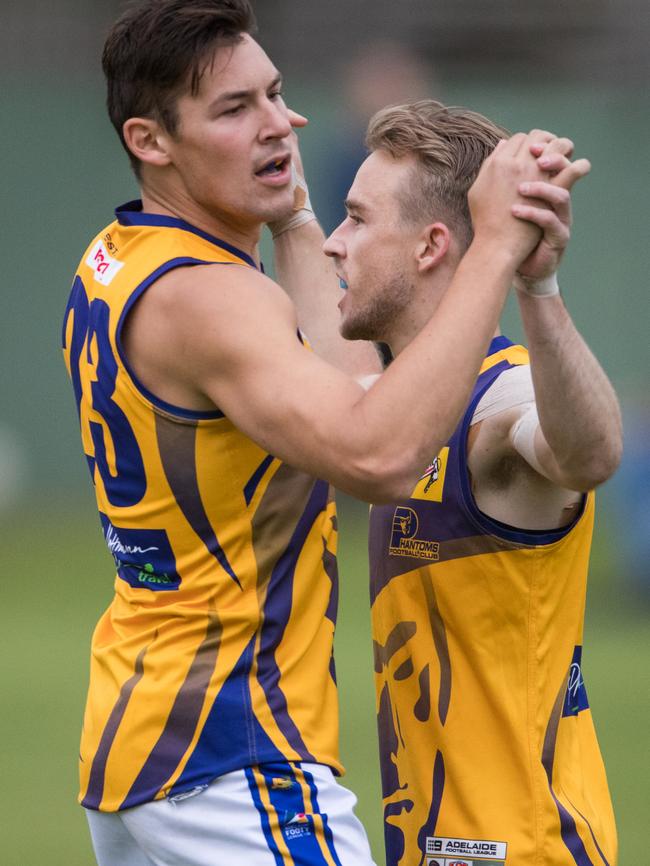 PHOS Camden's Harrison Cumming congratulating Daniel Hill on a goal against Pembroke at Haslam Oval.