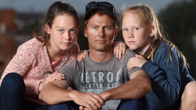 Arrium worker Lee Rodda with daughters Gabby, 11, and Ella, 10 outside his Whyalla home. Picture: Tom Huntley