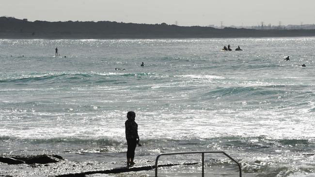 A person looks out over Cronulla Beach as gathering restrictions took place in Sydney. (AAP Image/Simon Bullard)