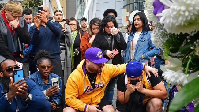 People gather around a makeshift memorial for Kobe Bryant at LA Live plaza in front of the Staples Centre in Los Angeles. Picture: AFP