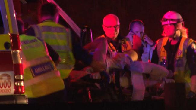 Paramedics treat police officer at the scene. Picture: TNV