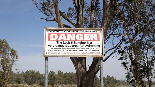 One of several signs warning of the dangers of swimming in the river. Picture: Simon Cross