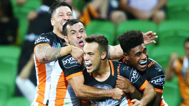 Luke Brooks celebrates scoring the winning try for Wests Tigers against the Storm.