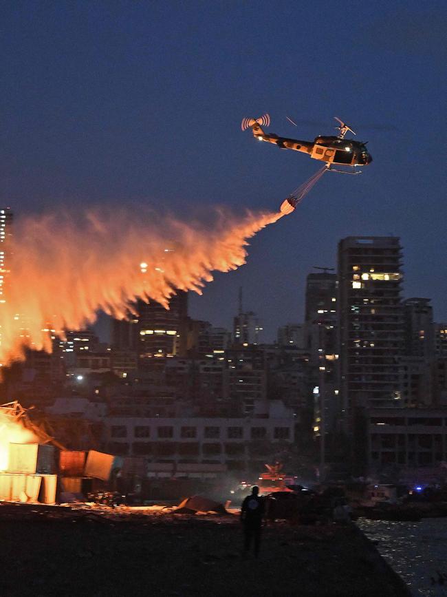 Helicopters putting out the flames after the explosion at the port. Picture: AFP