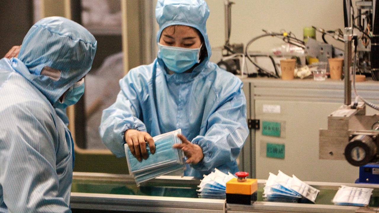 Workers producing face masks at a factory in Yangzhou in China's eastern Jiangsu province, to support the supply of medical materials during a deadly virus outbreak.