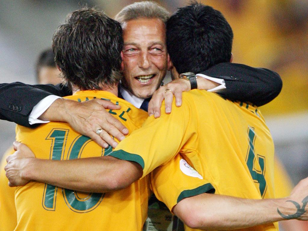 Then Socceroos assistant coach Johan Neeskens (centre) hugs Harry Kewell (left) and Tim Cahill at the FIFA 2006 World Cup. Picture: AFP