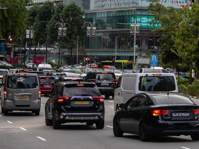 SINGAPORE, SINGAPORE - AUGUST 4: Cars drive on a street on August 4, 2023 in Singapore. Singapore, an island city-state in Southeast Asia is home to around 5 million people, and is the biggest hub in the region for wealth management and financial services. (Photo by Pita Simpson/Getty Images)