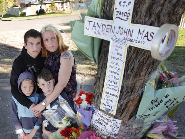 Jayden Mason’s mother Rebecca Payne (Mum) and other members of Jayden’s family at the roadside tribute erected after his death. (AAP image/ Mark Scott)