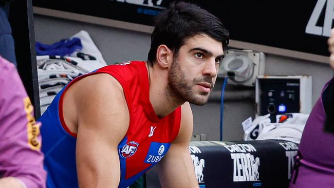 MELBOURNE, AUSTRALIA - JUNE 10: Christian Petracca of the Demons is seen on the bench after leaving the ground with a rib injury during the 2024 AFL Round 13 match between the Collingwood Magpies and the Melbourne Demons at The Melbourne Cricket Ground on June 10, 2024 in Melbourne, Australia. (Photo by Dylan Burns/AFL Photos via Getty Images)