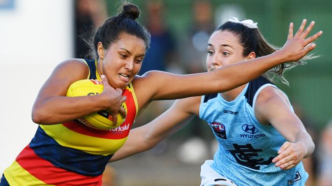 Adelaide’s Ruth Wallace looks to evade Carlton’s Nicola Stevens.