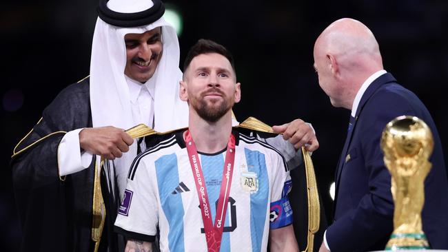 Lionel Messi of Argentina is presented with a traditional robe