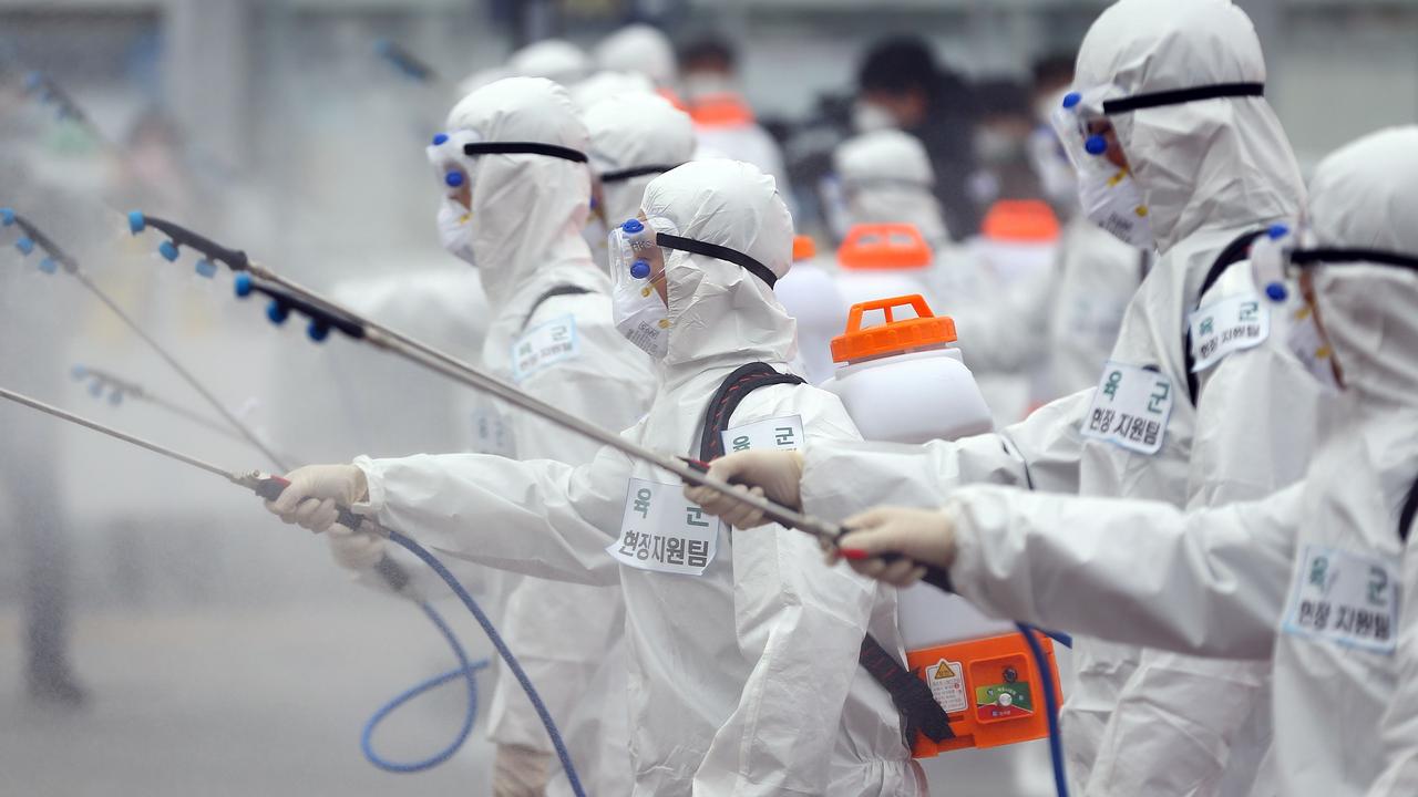 South Korean soldiers wearing protective gear spray disinfectant as part of preventive measures against the spread of the COVID-19. Picture: YONHAP/AFP