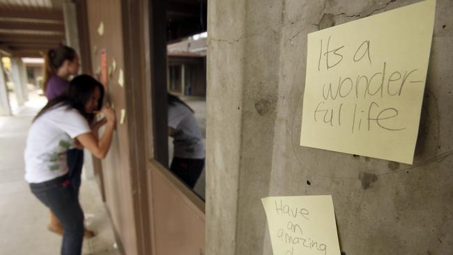 Fightback: Henry M. Gunn High School students stick Post-it notes with messages around their school after three Gunn students committed suicide. Picture: Tony Avelar/AP