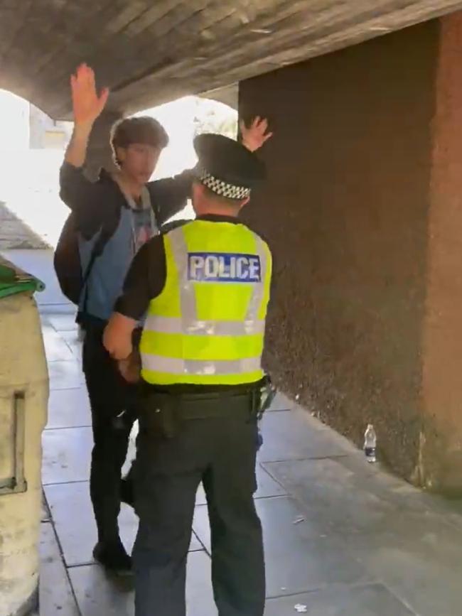 Police appeared to usher the man away from the coffin procession before he was later arrested.