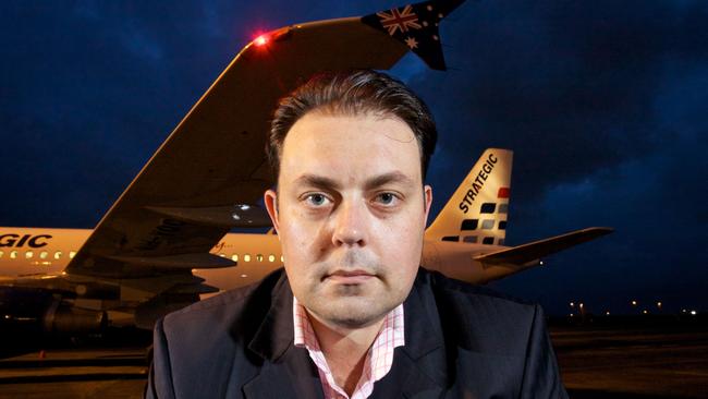 Former Strategic Airlines founder Michael James at Brisbane Airport with one of A320 planes in the fleet. Photo: Liam Kidston