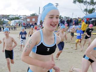 Amy Gooley runs to the starting line. The second day of the Schools Triathlon Challenge at Bellerive Beach.