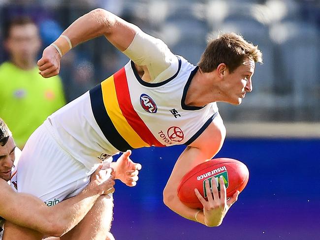 PERTH, AUSTRALIA - JUNE 10: Matt Crouch of the Crows is tackled by Hayden Ballantyne of the Dockers during the 2018 AFL round 12 match between the Fremantle Dockers and the Adelaide Crows at Optus Stadium on June 10, 2018 in Perth, Australia. (Photo by Daniel Carson/AFL Media/Getty Images)