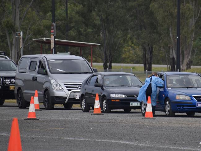 Ipswich locals queue for testing at the pop-up drive-through Covid testing site in the Raceview Hockey Grounds car park. 3 August, 2021. Photo: Ebony Graveur