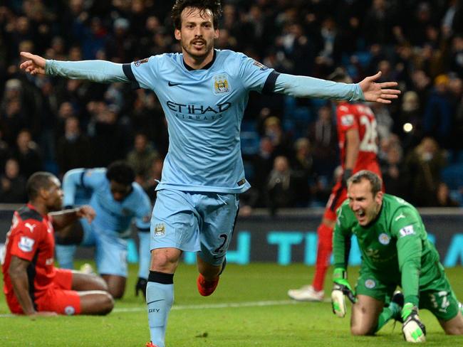 Manchester City's Spanish midfielder David Silva celebrates scoring the opening goal as Leicester City's Australian goalkeeper Mark Schwarzer reacts (R) during the English Premier League football match between Manchester City and Leicester City at the Etihad Stadium in Manchester, north west England, on March 4, 2015. AFP PHOTO / OLI SCARFF RESTRICTED TO EDITORIAL USE. NO USE WITH UNAUTHORIZED AUDIO, VIDEO, DATA, FIXTURE LISTS, CLUB/LEAGUE LOGOS OR 