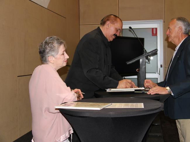 Authors of Colonisation Through Black Eyes, Dr Lysbeth Ford and Dr Kerry Blackman, sign a copy of the book at its launch. Picture Rodney Stevens