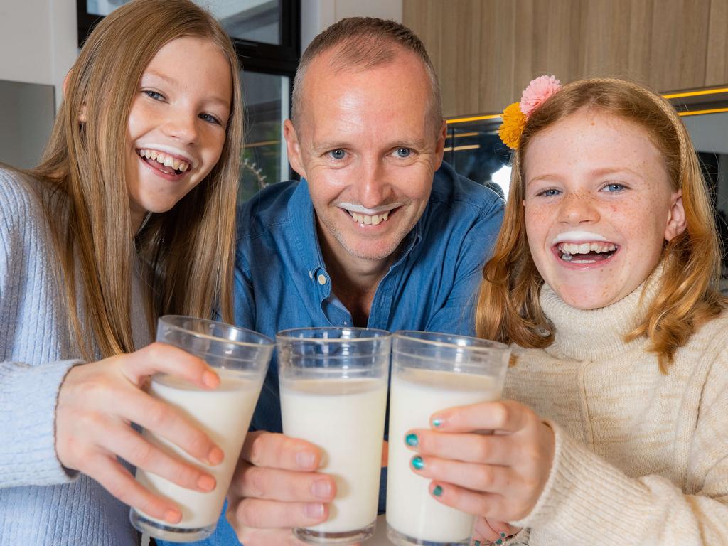 Ava Battye, 12, dad Anthony Battye and Macy Battye, 9, all love their milk and recognise the importance of dairy intake for health, development and nutrition. Picture: Jason Edwards