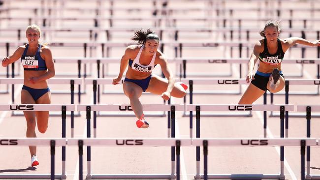 Michelle Jenneke, centre, competes in the 100m hurdles in Canberra yesterday.