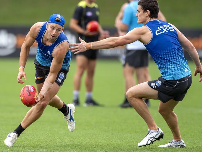 Dom Tyson fires out a handpass at North Melbourne’s final training sessions prior to Christmas.