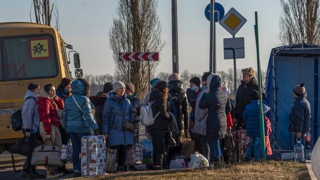 People evacuated from the self-proclaimed Donetsk People's Republic walk toward the Russian Emergency Ministry camp in the village of Veselo-Voznesenka on the Azov Sea coast. Picture: AFP