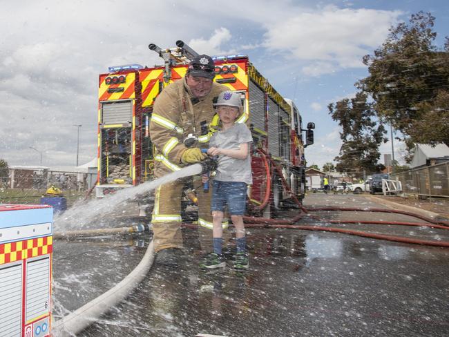 Brad Morpeth of the CFA and young Liam Palmer. Swan Hill Show 2024. Picture: Noel Fisher.