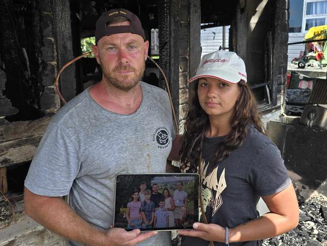 Daniel and Gemma O'Brien with the shards of what's left of their family home after a blaze tore through their house on Sunday. Picture: Luke Kane