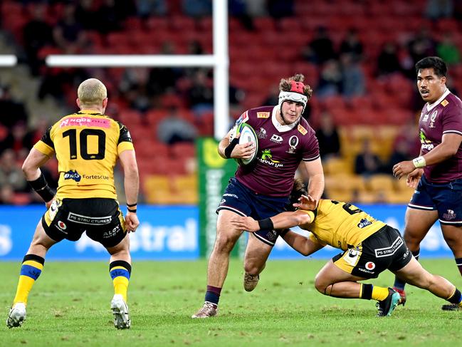 BRISBANE, AUSTRALIA - JULY 17: Fraser McReight of the Reds takes on the defence during the round three Super Rugby AU match between the Reds and Force at Suncorp Stadium on July 17, 2020 in Brisbane, Australia. (Photo by Bradley Kanaris/Getty Images)