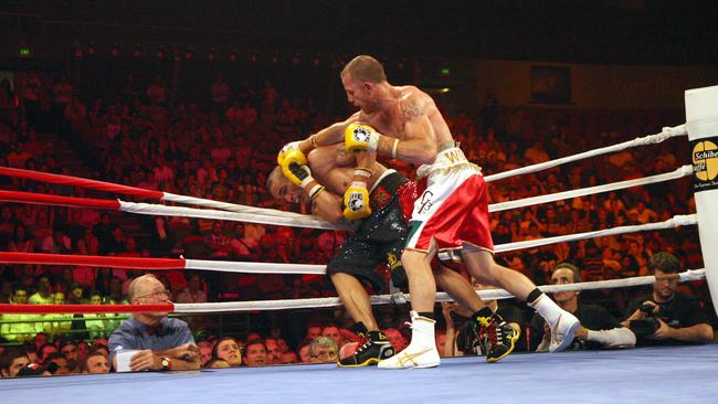 Wood mauled Mundine on the ropes.