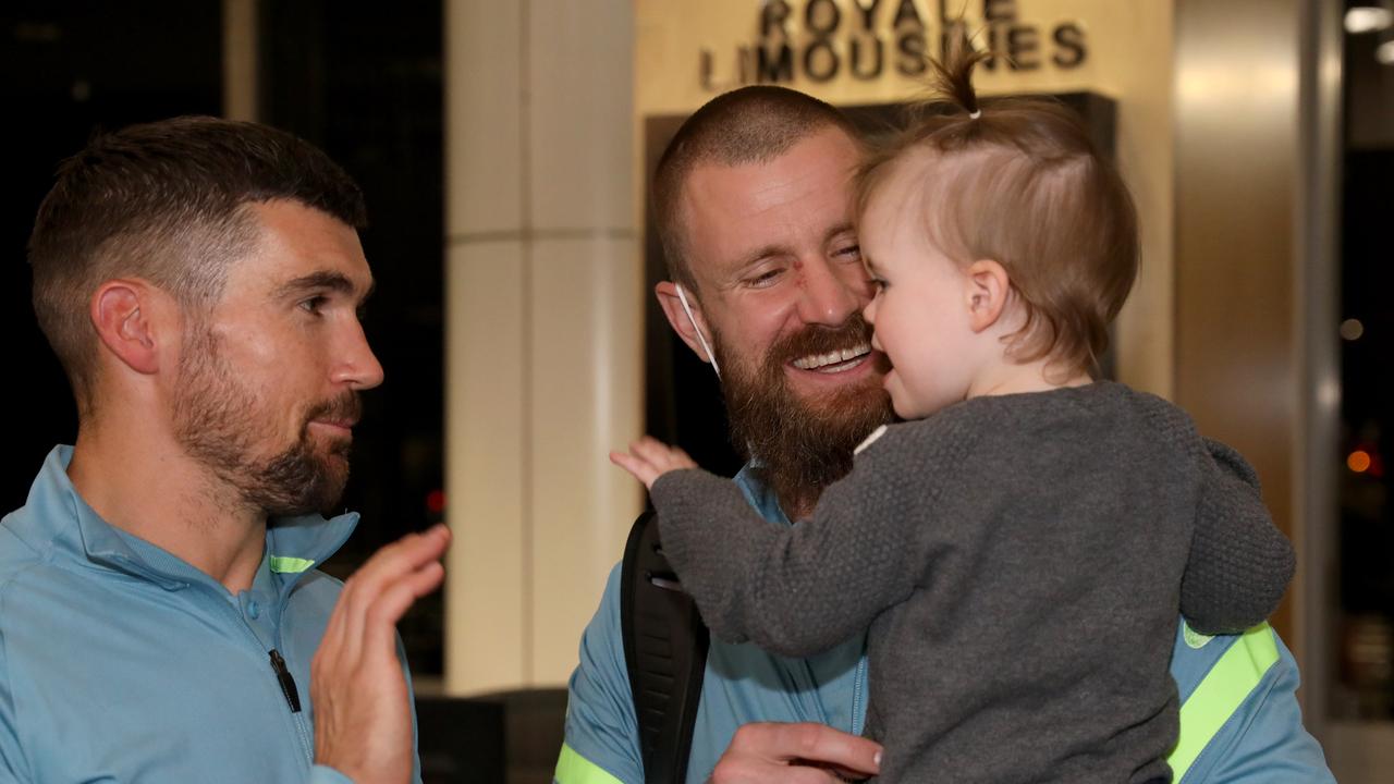 Socceroos Andrew Redmayne with his 17 month old daughter Poppy getting a high five from captain Mathew Ryan. Picture: Damian Shaw
