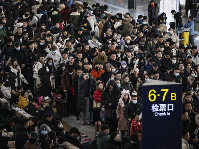 Travellers line-up as they wait to board sold out high speed trains during the travel rush for the Lunar New Year. The Chinese government has given workers an extra day of public holiday leave this year. Picture: Kevin Frayer/Getty Images