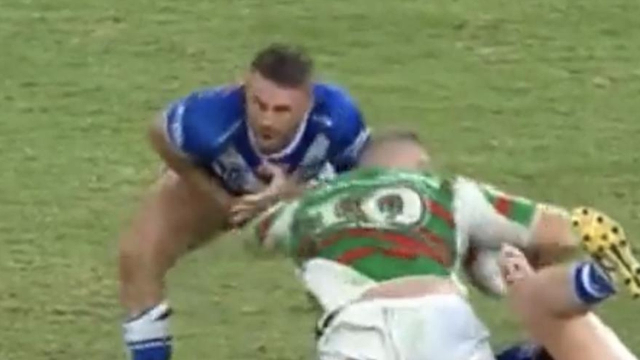Josh Reynolds winces in pain after tackling Tom Burgess.