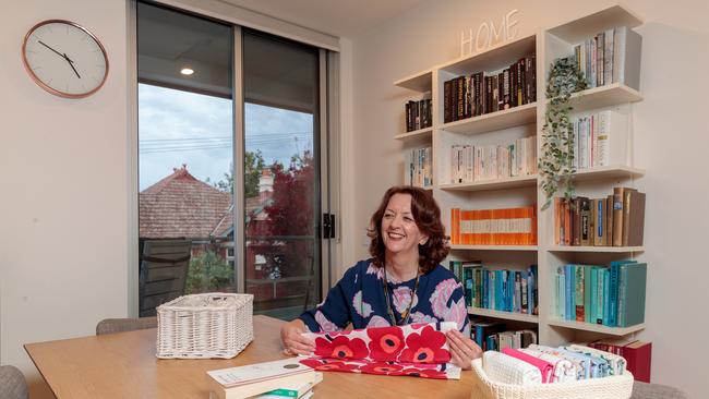 Sharon Hallett at home demonstrating Marie Kondo’s folding tips.