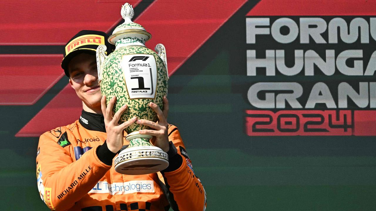 Team McLaren’s Oscar Piastri celebrates on the podium with the trophy after winning the Hungarian Grand Prix at the Hungaroring racetrack near Budapest on July 21. Picture: Attila Kisbenedek/AFP