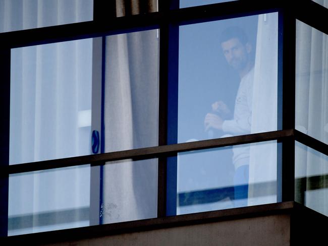 ADELAIDE, AUSTRALIA - NewsWire Photos JANUARY 15, 2021: Tennis superstar Novak Djokovic looks out of the window of his quarantine hotel, M Suites on Tynte Street in North Adelaide. Picture: NCA NewsWire / Naomi Jellicoe