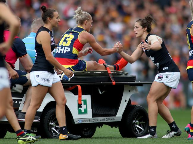 Crows co-captain Erin Phillips is taken from Adelaide Oval after injuring her knee in the third quarter of the AFLW grand final. Picture: AAP/Kelly Barnes