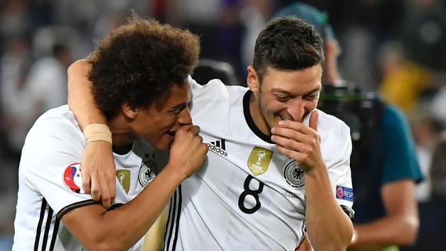 Germany's midfielder Mesut Oezil (R) and Germany's midfielder Leroy Sane celebrate.
