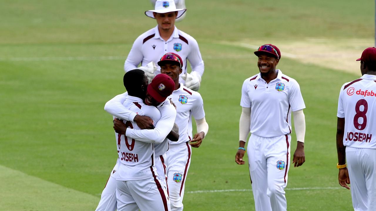 Shamar Joseph celebrates with teammates after taking another wicket at the Gabba. (Photo by Bradley Kanaris/Getty Images)