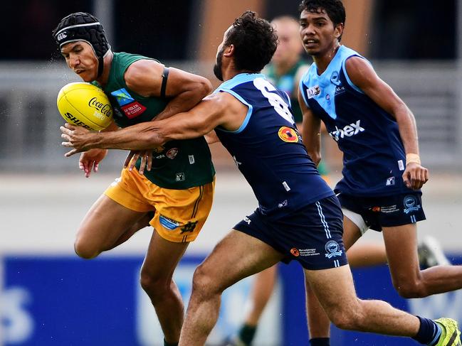 St.Mary's Ben Rioli tries to hang on to possession as Darwin Buffaloes' Jarrod Stokes comes in for the tackle during Saturday's game at TIO.Picture: Just in Kennedy