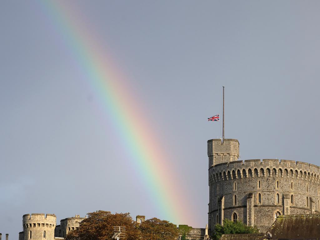 The Union flag is lowered on Windsor Castle as a rainbow covers the sky. Picture: Getty Images.