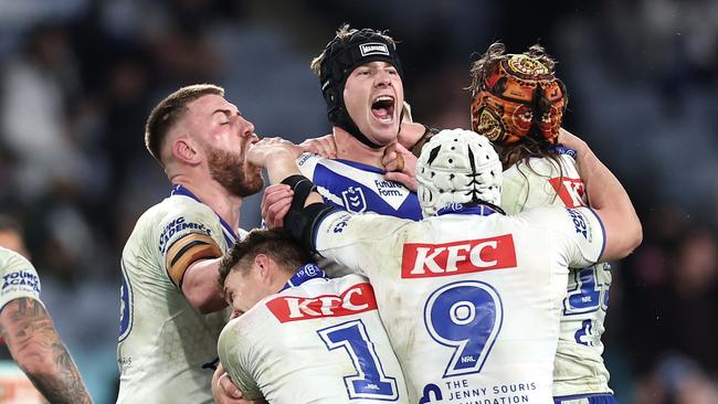 SYDNEY, AUSTRALIA - JUNE 28:  Matt Burton of the Bulldogs celebrates with team mates after kicking a golden point field goal in extra time to win the round 17 NRL match between Canterbury Bulldogs and Cronulla Sharks at Accor Stadium on June 28, 2024, in Sydney, Australia. (Photo by Cameron Spencer/Getty Images)